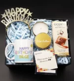 خرید لیوان تبریک تولد و تاج تولدت مبارک و شمع جعبه فلزی طلایی و ست هدیه شکلاتی گودیوا (ترکیه)